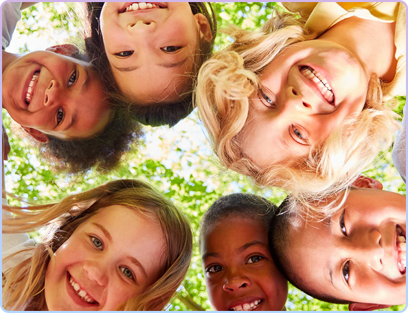 A group of smiling children looking down into the camera from above